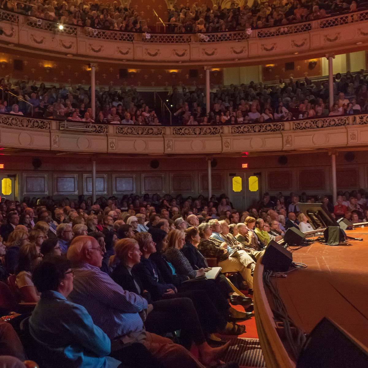 Wide shot of the Carnegie Music Hall audience listening to a lecture